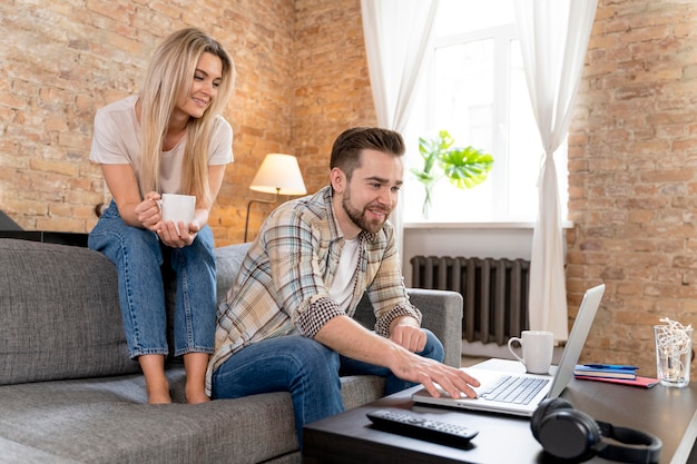 Couple à la maison ayant un appel vidéo avec la famille