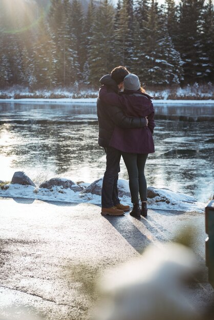 Couple romantique au bord de la rivière en hiver