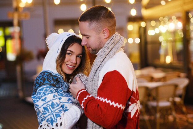 Un couple romantique heureux a rendez-vous le jour de Noël dans la rue.