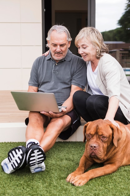 Couple Senior avec chien dans le jardin