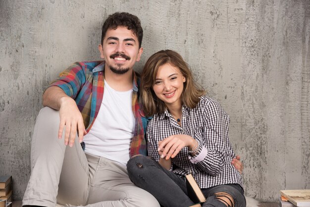 couple souriant assis sur le sol