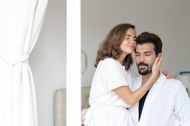 Photo gratuite couple souriant se détendre et couples câlins au lit