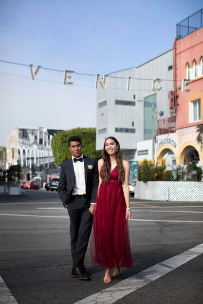 Couple en vêtements de bal de fin d'études posant ensemble