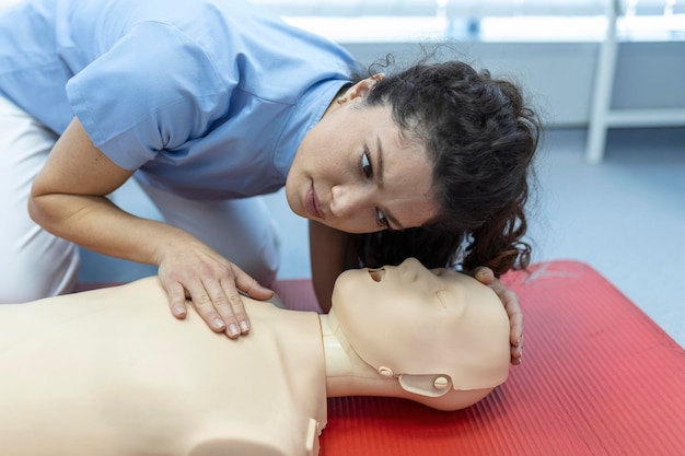 Cours de RCR avec des instructeurs parlant et démontrant les premières compressions d'aide et la procédure de réanimation