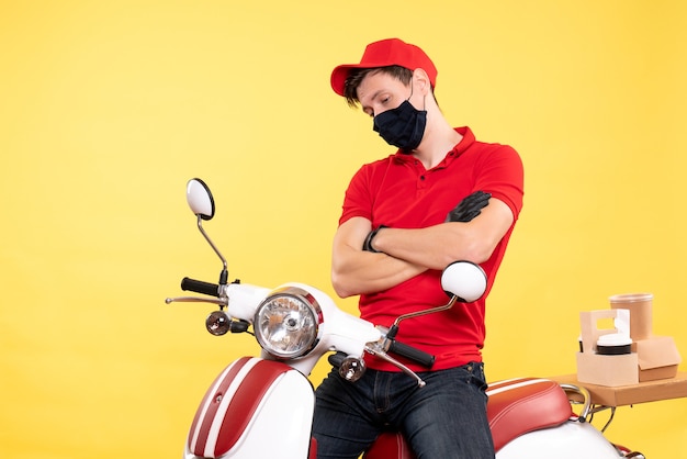 Coursier mâle vue de face en uniforme et masque sur jaune