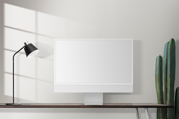 Écran d'ordinateur vide sur un bureau dans un bureau à domicile rétro