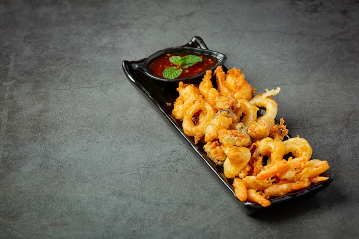 Photo gratuit crevettes et calamars frits avec sauce épicée