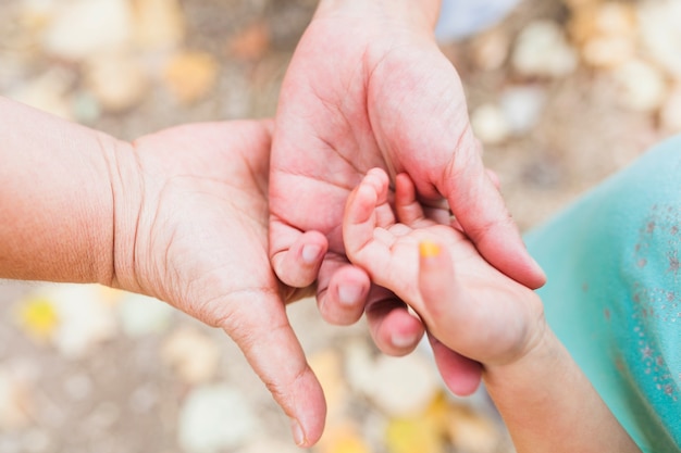 Crop mère tenant la main de l&#39;enfant