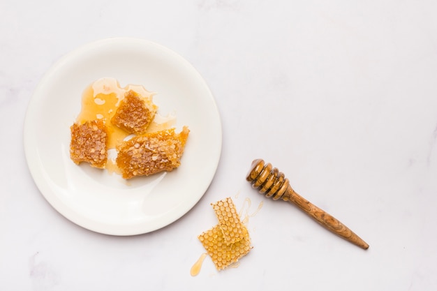 Cuillère à miel vue de dessus avec des morceaux de nid d&#39;abeille