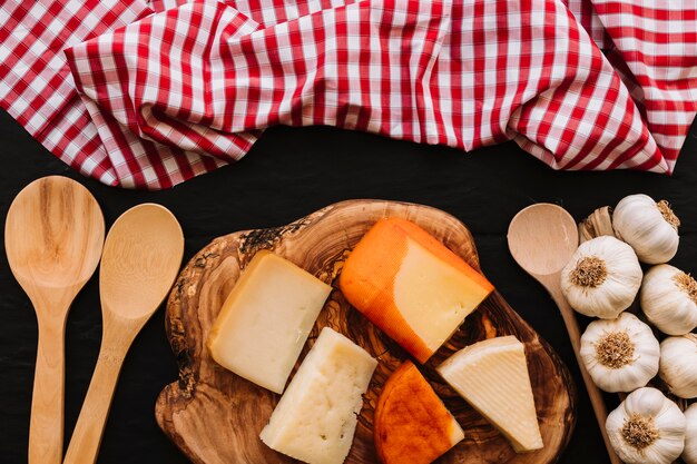 Cuillères et serviettes de table près du fromage et de l&#39;ail