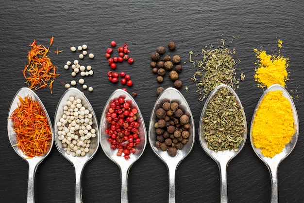 Photo gratuite cuillères vue de dessus avec des condiments en poudre