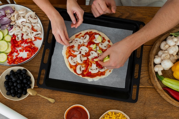 Photo gratuite cuisinier vue de dessus préparant une pizza