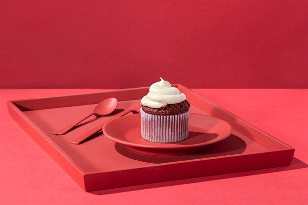 Cupcake à angle élevé avec de la crème sur une assiette