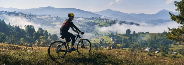 Cycliste masculin faisant du vélo dans les montagnes