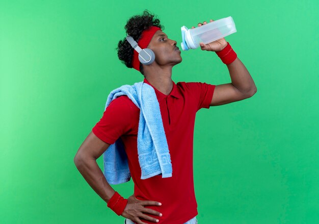 Debout en vue de profil jeune homme sportif portant un bandeau