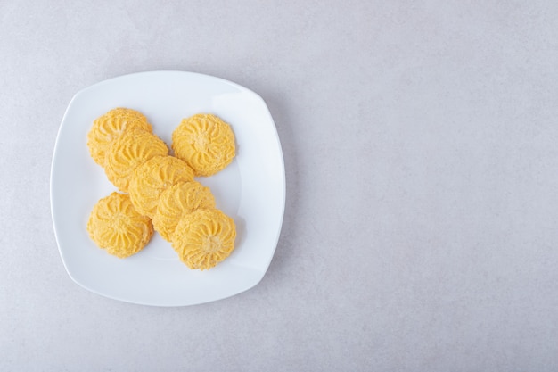 De délicieux biscuits sur une assiette, sur le marbre.