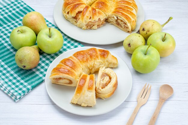 Délicieux bracelet de pâtisserie cuit formé à l'intérieur de la plaque de verre avec des pommes et des poires sur un sol léger biscuit pâtisserie