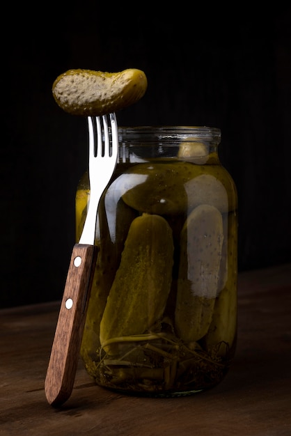 Délicieux cornichons en pot avec une fourchette