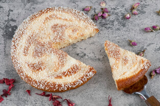 Délicieux gâteau rond haché placé sur une table en marbre.