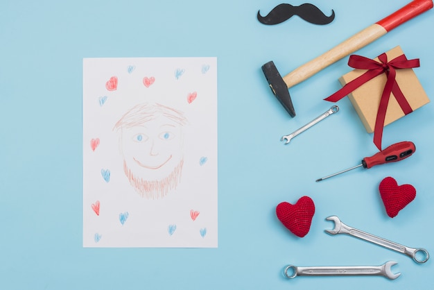 Dessin d&#39;homme avec des outils et une boîte cadeau