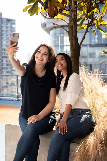 Deux amies sur un toit-terrasse prenant un selfie