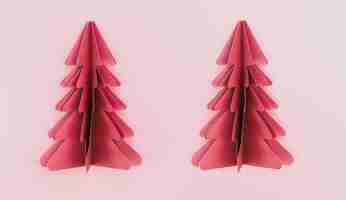 Photo gratuite deux arbres de noël origami en papier rose sur fond rose isolés