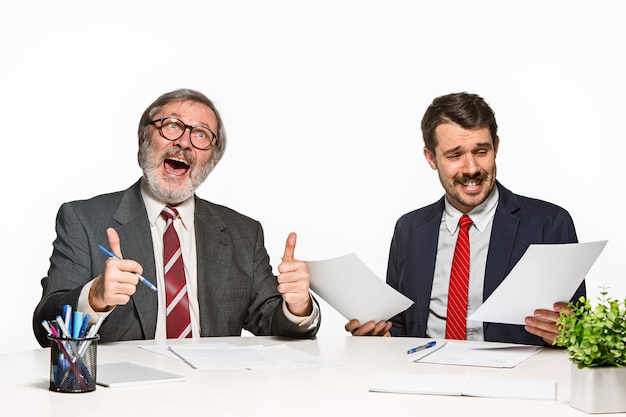 Photo gratuite les deux collègues travaillant ensemble au bureau sur blanc.