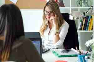 Photo gratuite deux femmes d'affaires travaillent dans son bureau.