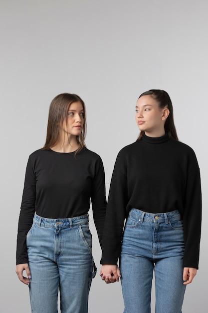 Deux filles portant un t-shirt noir posant en studio