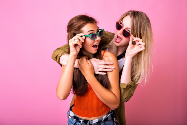 Deux meilleurs amis positifs s'amusant avec des lunettes de soleil