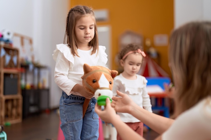 Photo gratuit deux petites filles jouant avec des jouets à la maternelle.