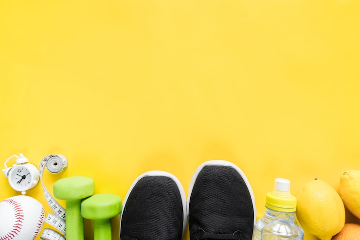 Photo gratuit divers articles de sport sur fond jaune