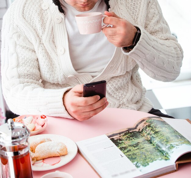 Divers cookies avec du thé et un magazine sur la table