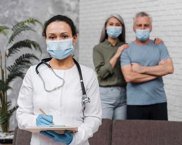 Photo gratuite docteur posant avec ses patients derrière