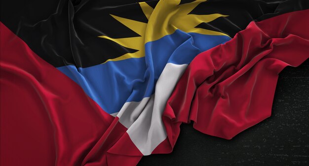 Le drapeau d&#39;Antigua-et-Barbuda est irrégulier sur un fond sombre 3D Render