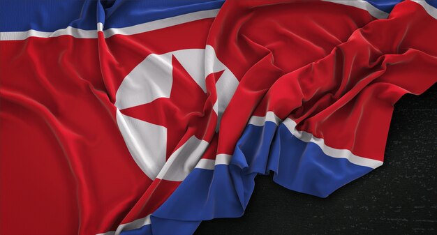 Drapeau de Corée du Nord enroulé sur un fond sombre 3D Render