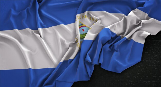 Drapeau du Nicaragua enroulé sur un fond sombre 3D Render