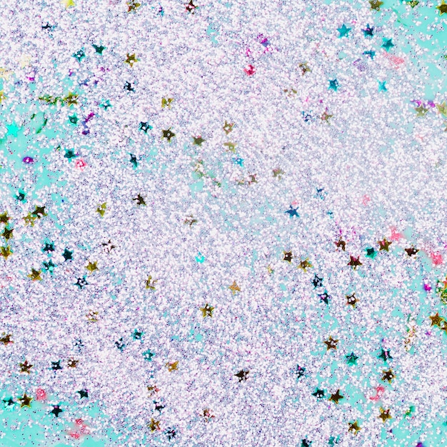 Photo gratuite eau turquoise peinte avec paillettes et étoiles étoilées