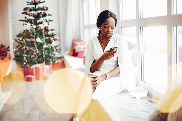 élégante fille noire dans une chambre à Noël