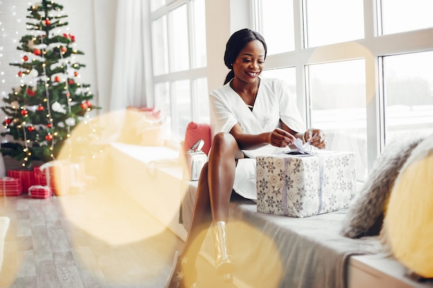 élégante fille noire dans une chambre à Noël