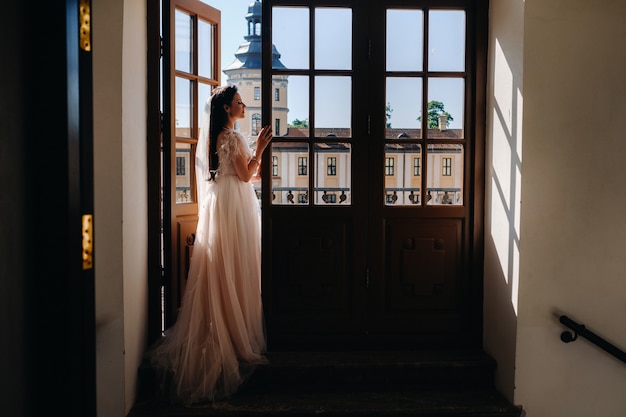 Une élégante mariée sur le balcon d'un ancien château de la ville de nesvizh.