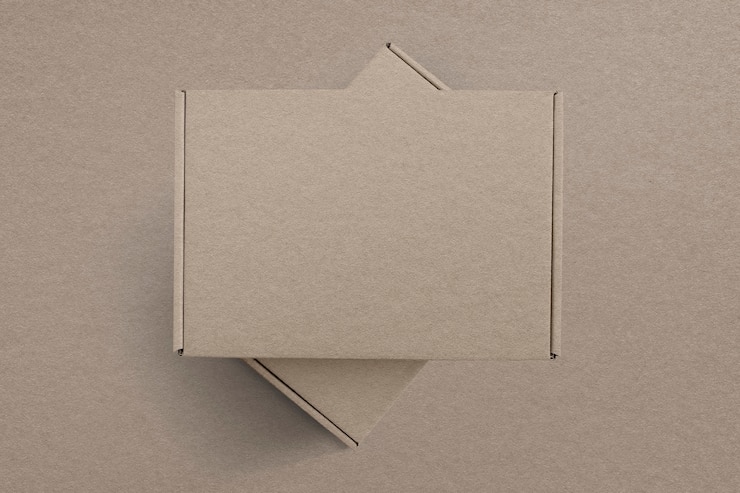 Photo gratuit emballage de produit en boîte brune en papier kraft avec espace de conception à plat