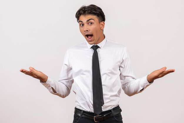 Employé de bureau mâle vue de face debout sur le mur blanc travail d'affaires mâle