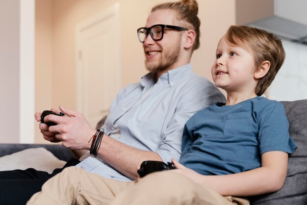 Enfant et père de tir moyen jouant