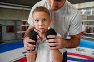 Photo gratuite enfant vue de face pratiquant la boxe