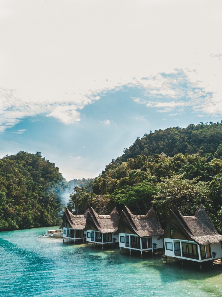 Photo gratuit ensemble de cottages sur l'océan sous le ciel bleu