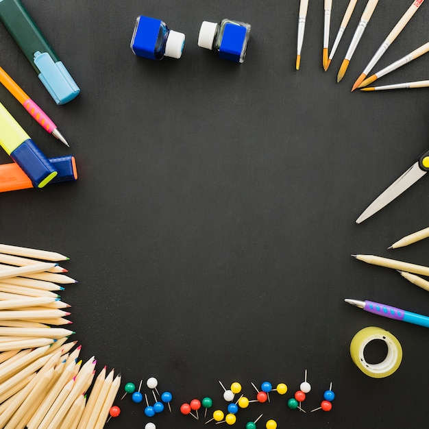 Ensemble de matériel scolaire sur bureau noir