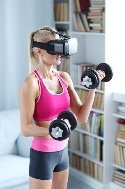 Entraînement de fitness femme avec haltères et casque vr