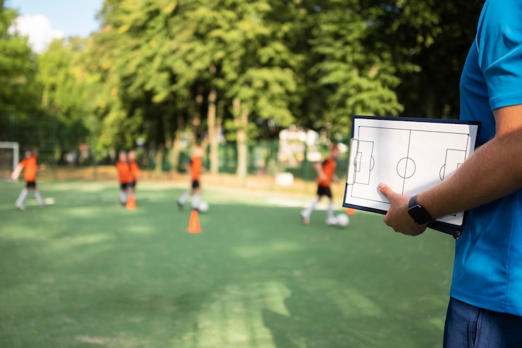 Photo gratuit entraîneur de football enseignant à ses élèves