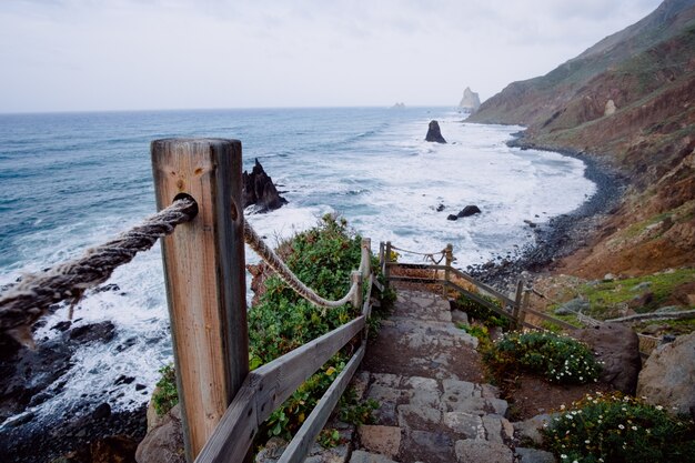 Escalier rustique descendant menant au rivage d'une montagne